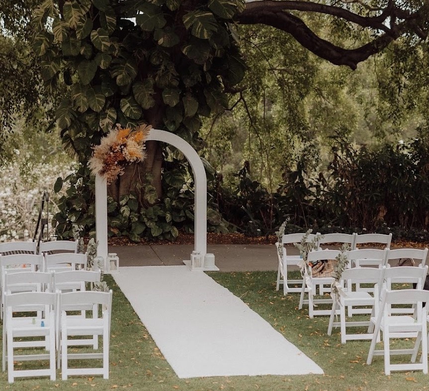 White curved wedding arbor