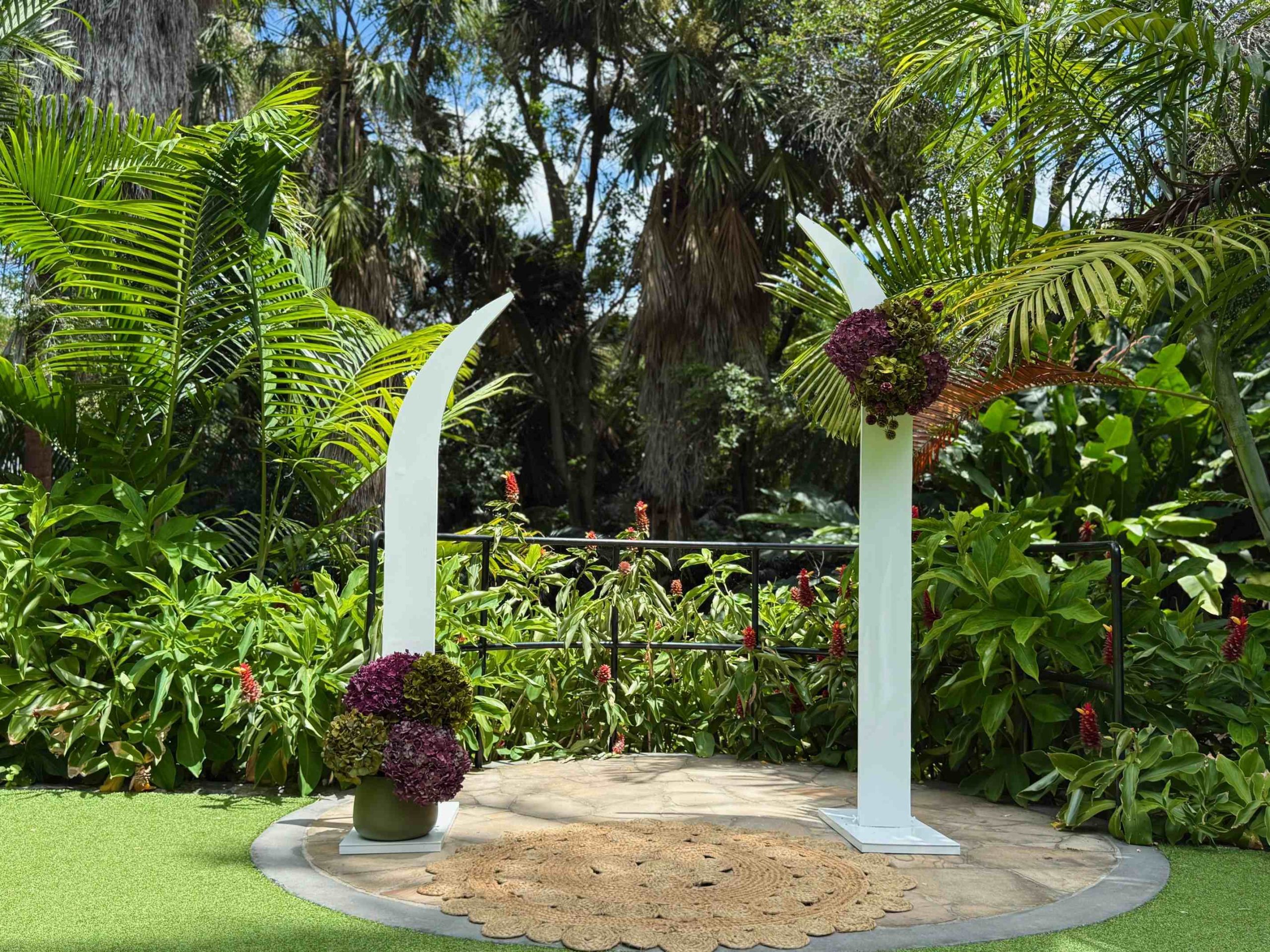 arch shaped wedding plinths with pinot and pistachio or plum and green coloured flower combo