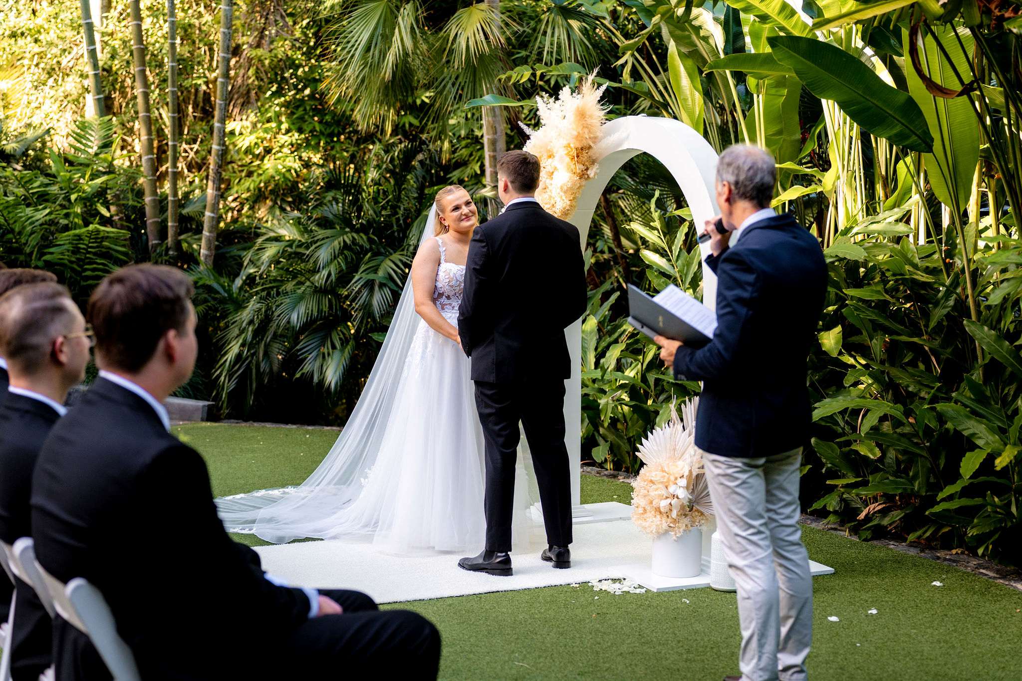 Celebrant Jamie Eastgate delivering an enjoyable heartfelt ceremony, while stood off to one side allowing the focus to be about the couple, as the bride looks lovingly into her grooms eyes