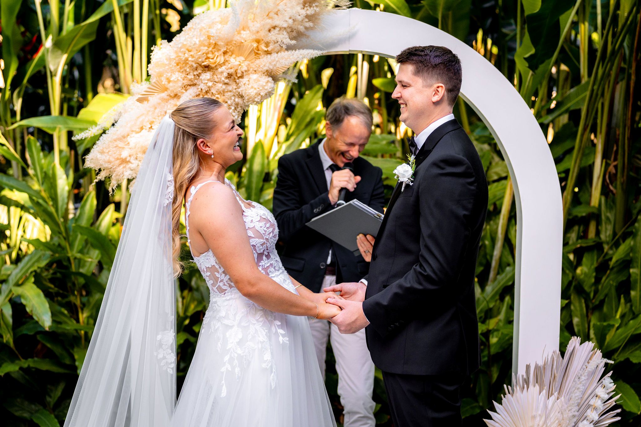 Celebrant Jamie Eastgate bringing the happy vibes to a wedding ceremony with the bride and groom smiling and laughing having the best ceremony