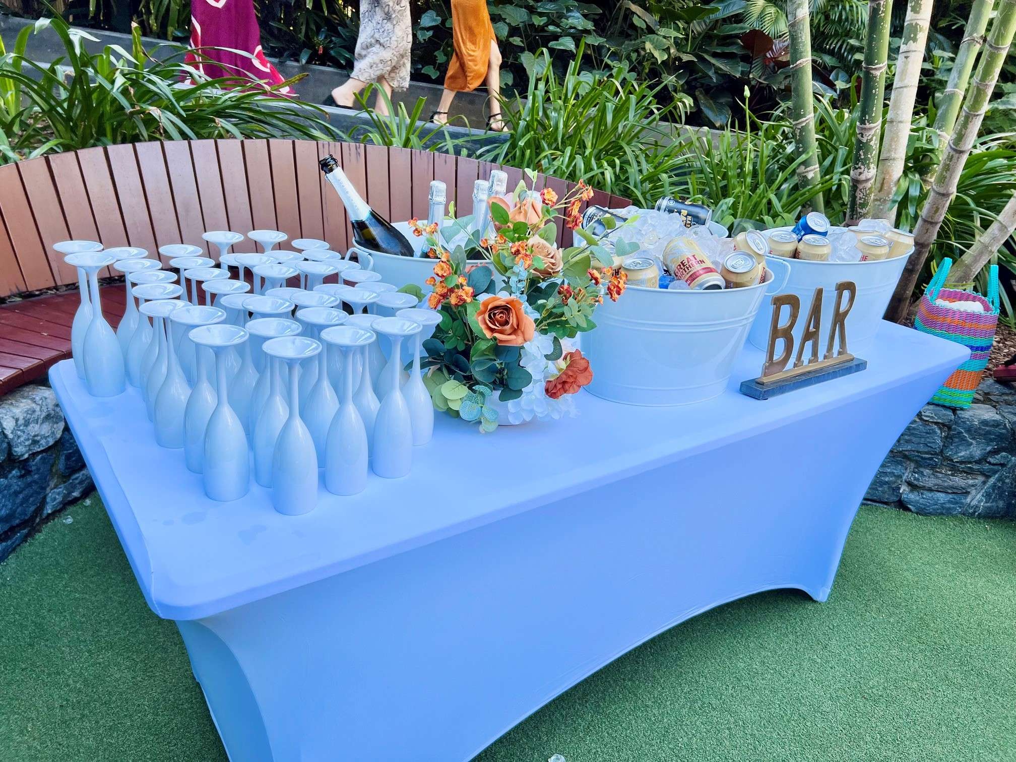 outdoor drink station with white champagne glasses